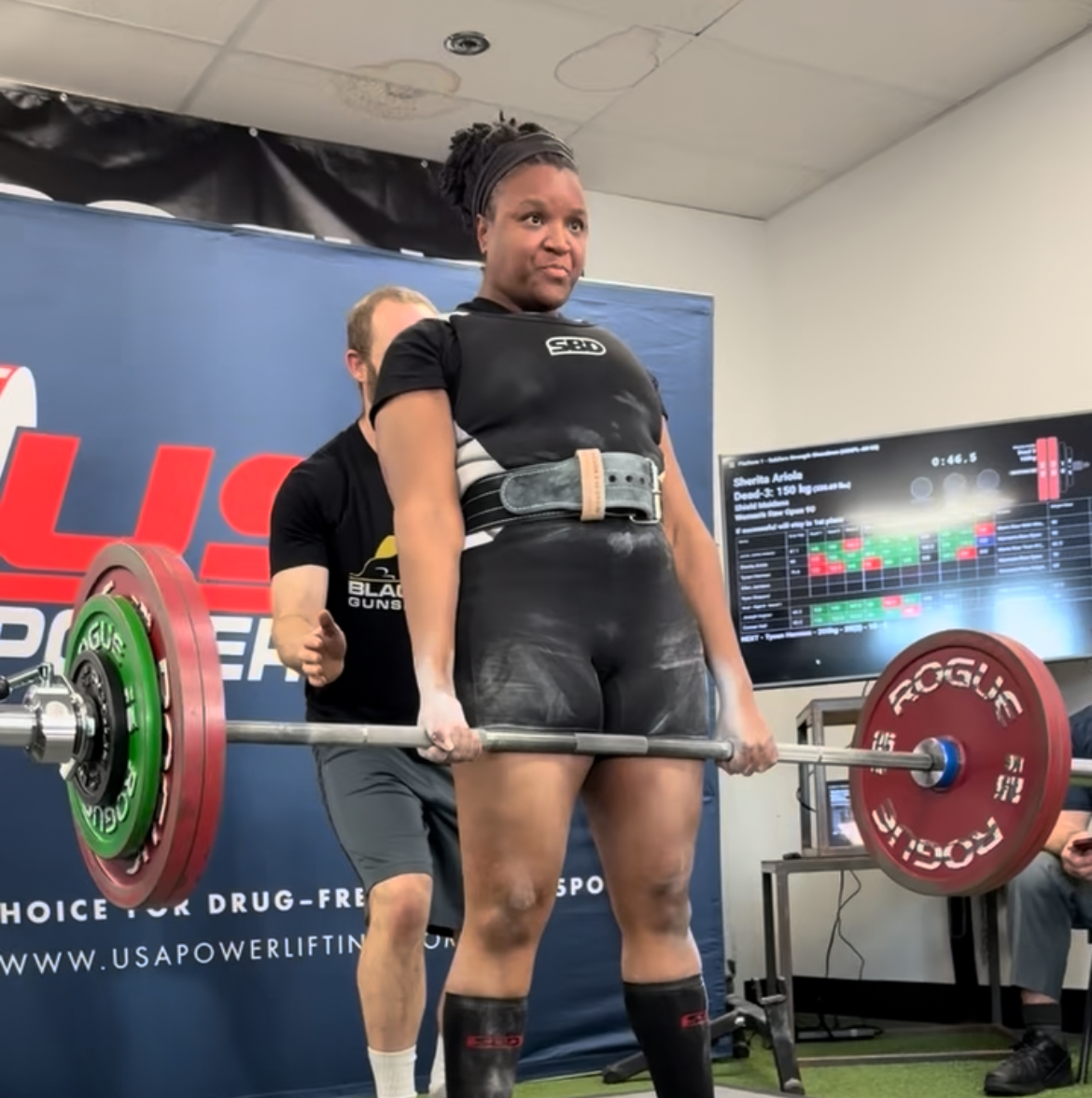 Sherita Ariola locking out a 150kg deadlift at a USA Powerlifting meet